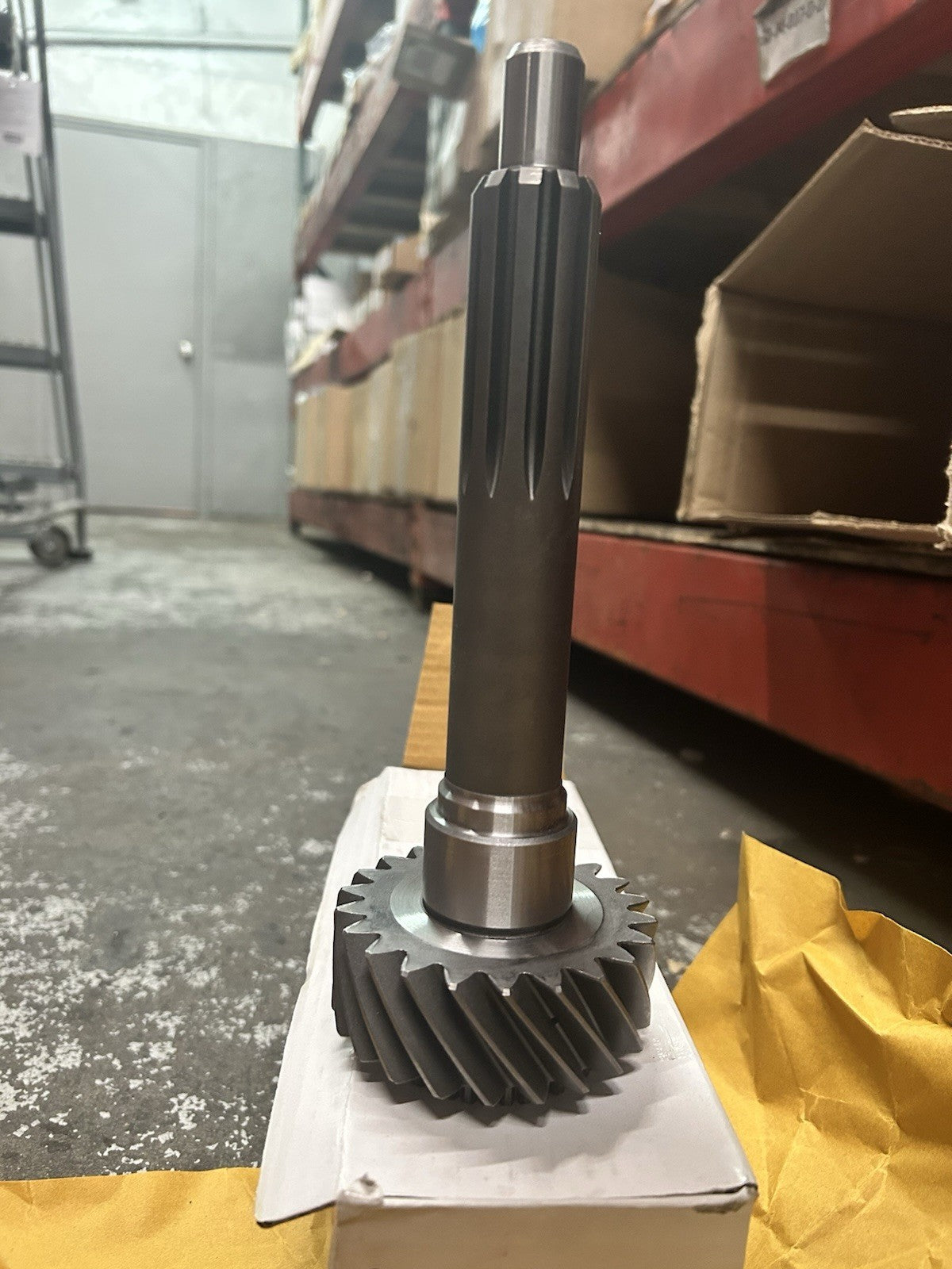 Nv4500 22T Input displayed on a box, featuring a gear with a splined shaft, shot in a warehouse setting.