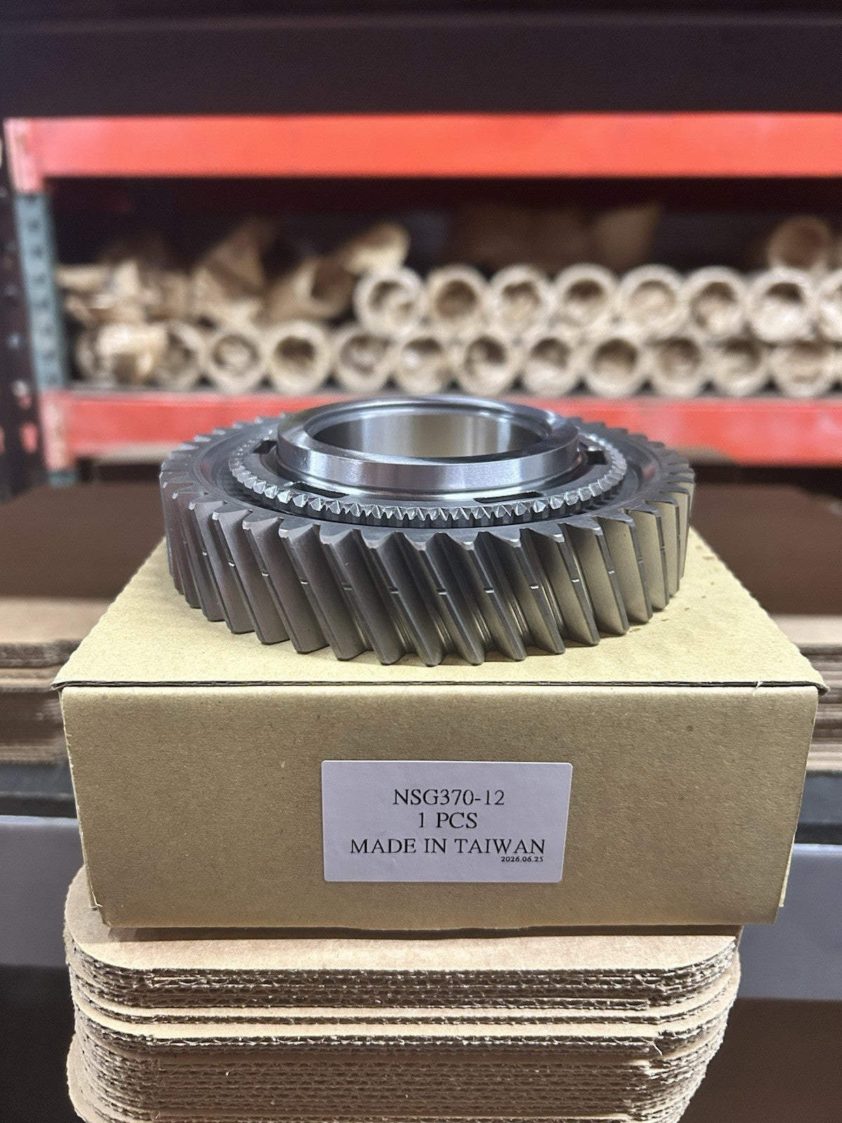 Upgraded NSG370 1st Gear displayed on packaging, highlighting its precise design and quality.