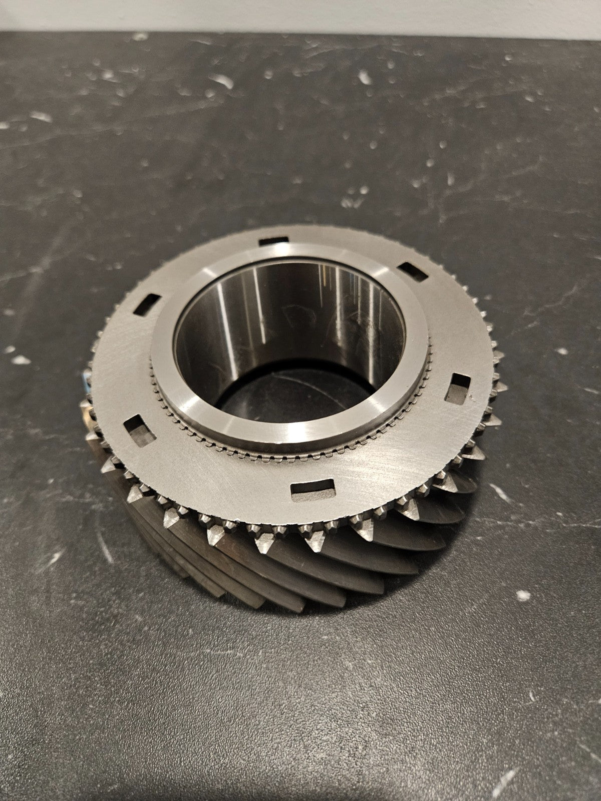 ZF S6-750 2nd gear mainshaft 37T displayed on a black surface, showcasing its detailed design and features.