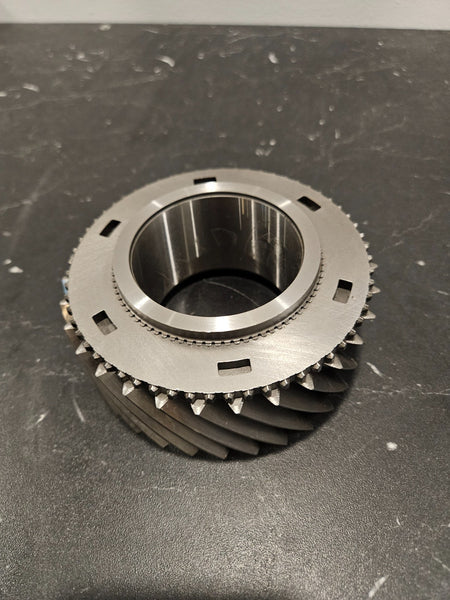 ZF S6-750 2nd gear mainshaft 37T displayed on a black surface, showcasing its detailed design and features.