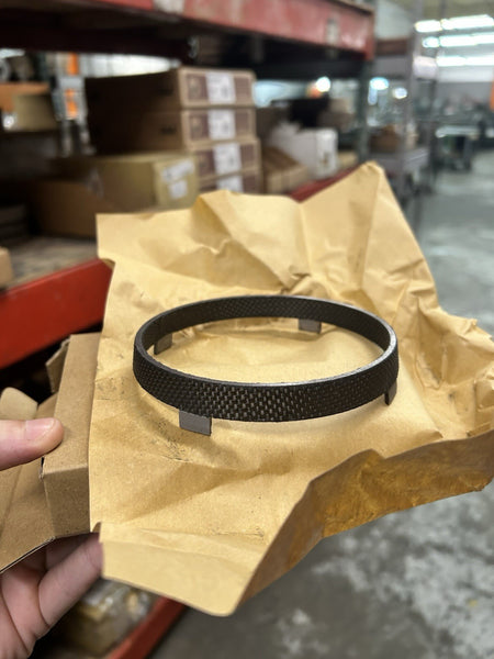 NV4500 1-2 Synchro Fiber Ring resting on brown wrapping paper, highlighting its durable design for manual transmissions.