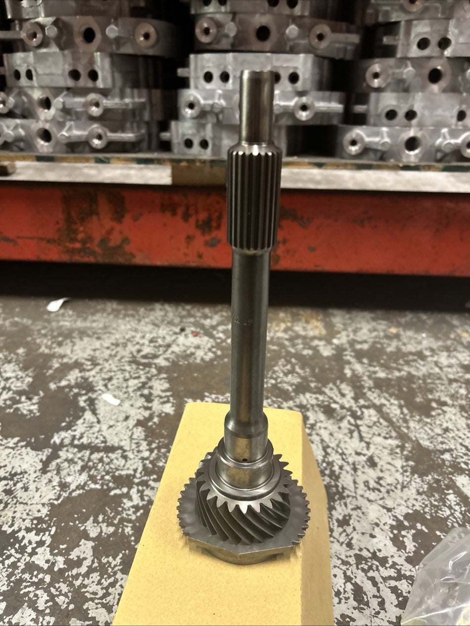 M5R1 23t Input Shaft on a cardboard base, showcasing its intricate gear design and metal finish.