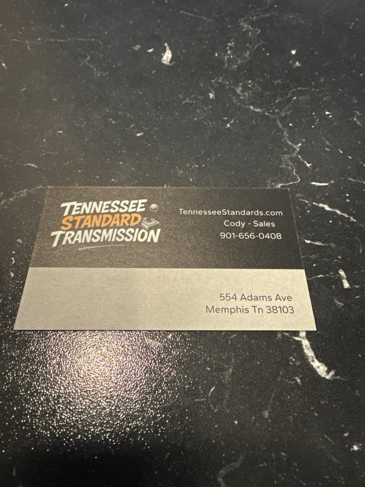 Business card for Tennessee Standard Transmission featuring contact details and address.