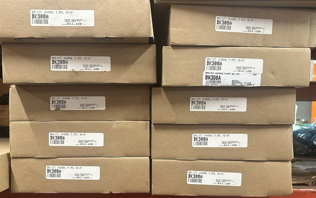 Nv4500 5 Speed bearing Kit Bk308a packages stacked on shelf with labels visible.