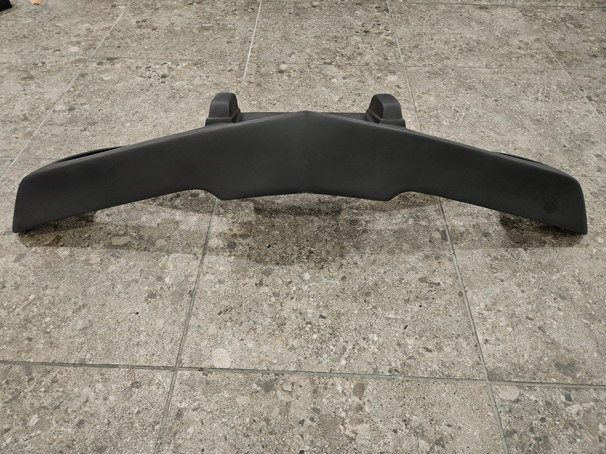 1975-1979 C3 Corvette fiberglass bumper displayed on a tiled surface, brand new and never installed.