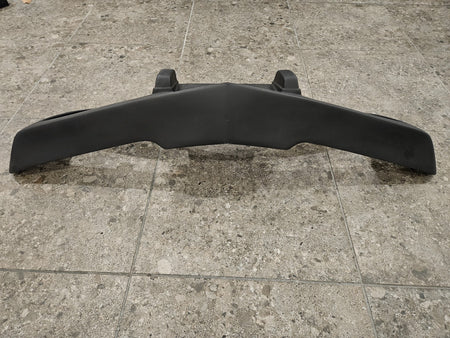 1975-1979 C3 Corvette fiberglass bumper displayed on a tiled surface, brand new and never installed.