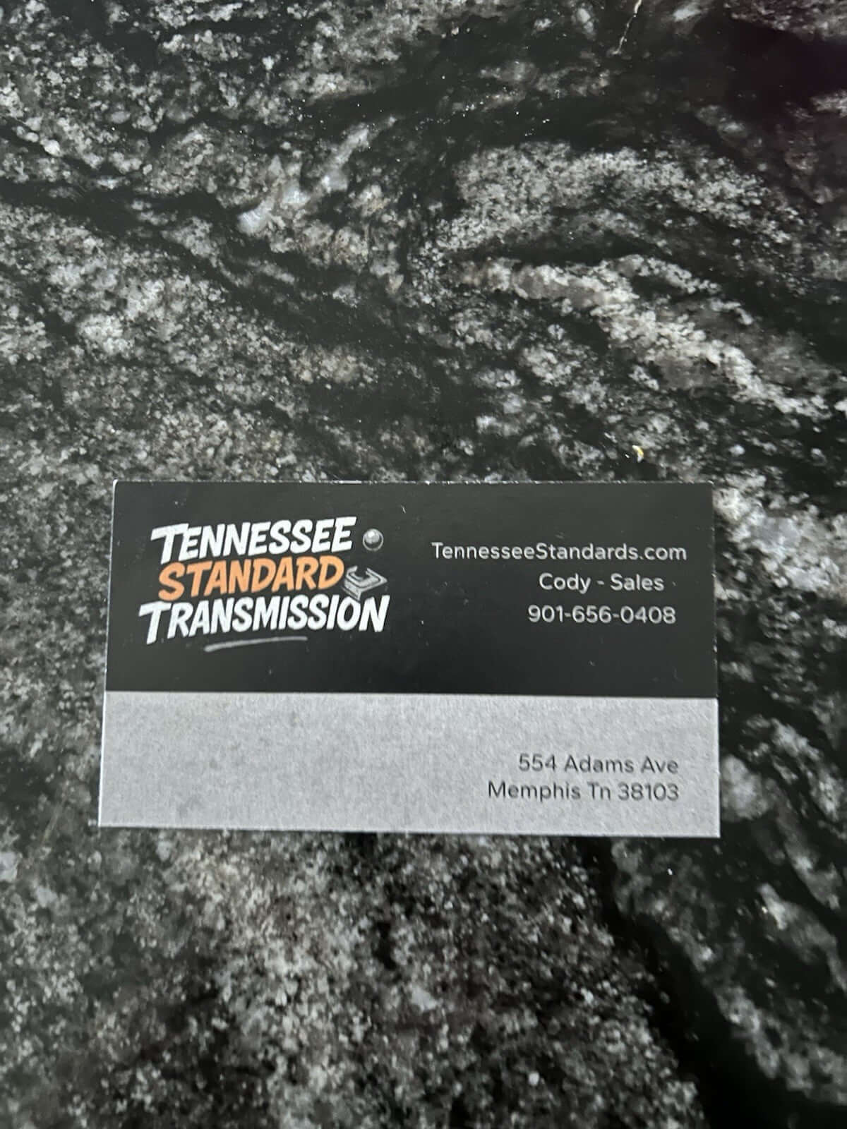 Business card of Tennessee Standard Transmission featuring contact information and website.
