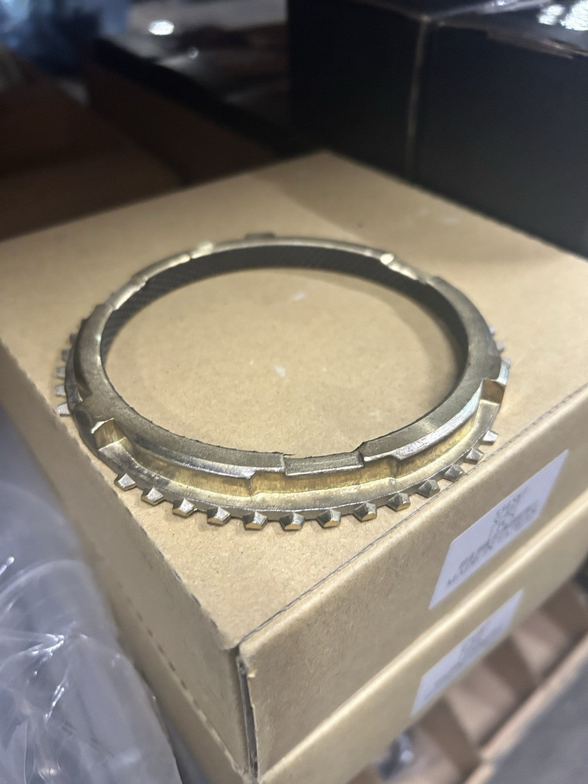 Nv4500 3-4 Synchro part on cardboard box, designed for manual transmission gear synchronization.