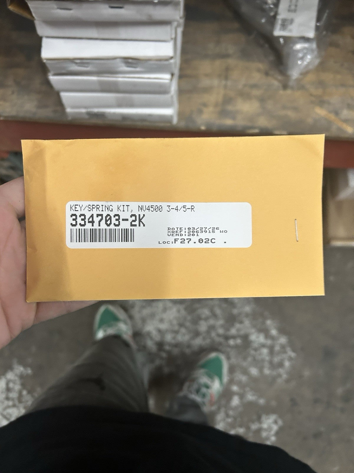 Nv4500 3/4 Spring And key Set package showing model number 334703-2K, with yellow envelope in storage setting.