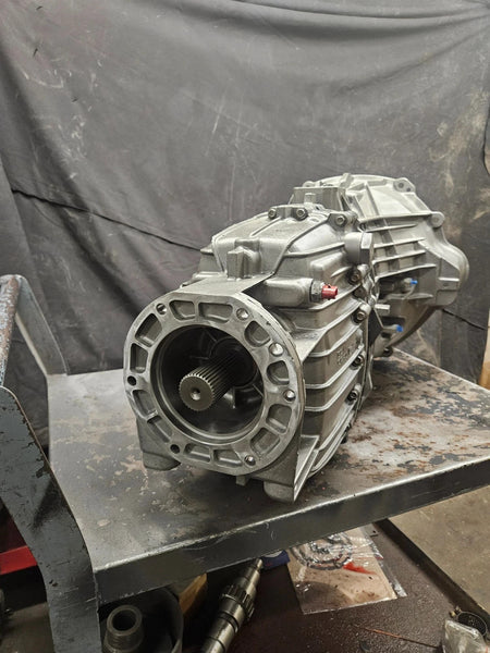 ZF 6 SPD manual transmission displayed on a workbench, showcasing its quality and detailed craftsmanship.