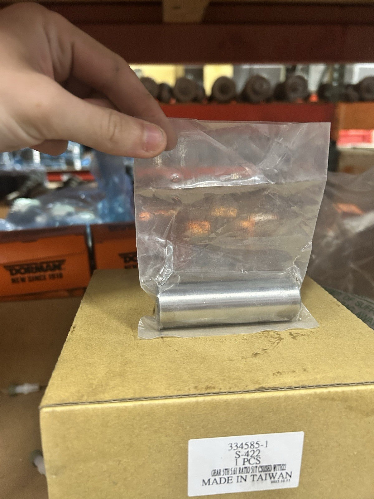 Nv4500 Reverse Idler Pin in packaging, displayed on a box for visibility, showing product details and clean design.