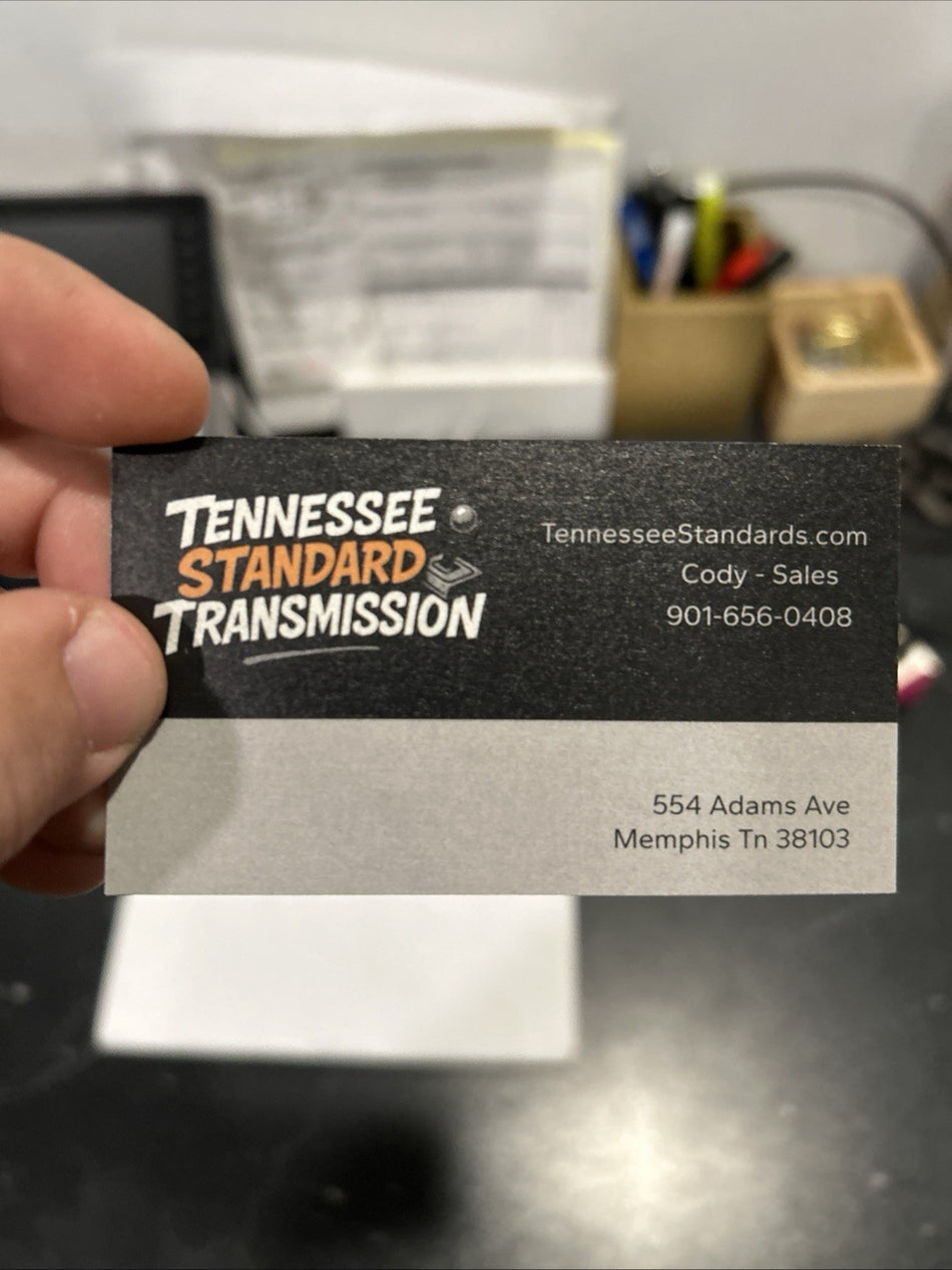 Business card for Tennessee Standard Transmission featuring contact details and logo.