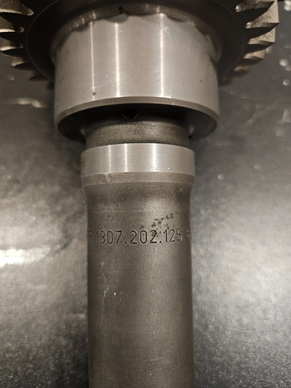 ZF S5-42 input shaft for Ford trucks showing detailed close-up of part number 1307-202-125 etched on the shaft.