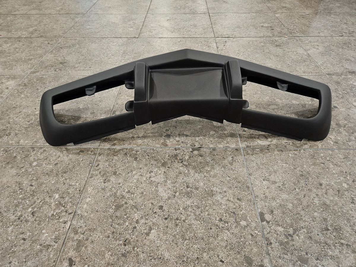 1975-1979 C3 Corvette fiberglass bumper displayed on a tiled surface, brand new and never installed.
