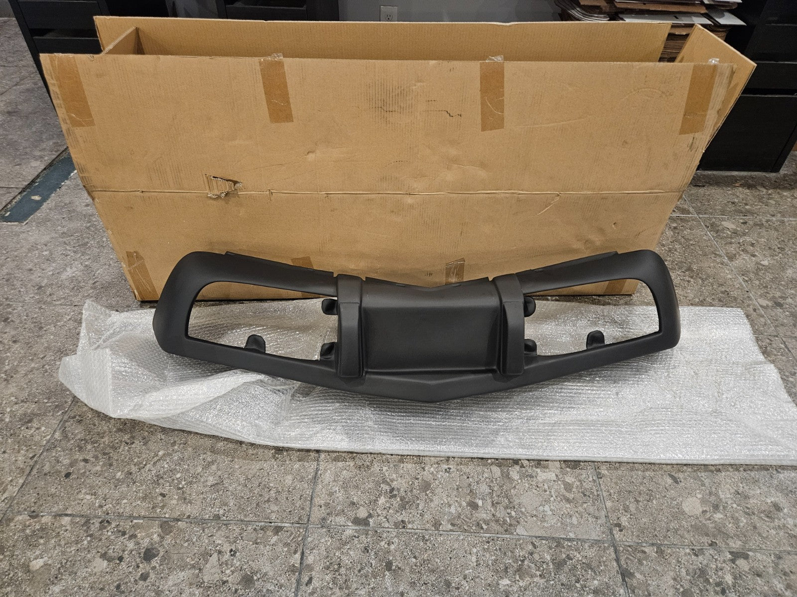 New fiberglass front bumper for 1975-1979 C3 Corvette, part # LYAP-603, shown in packaging.