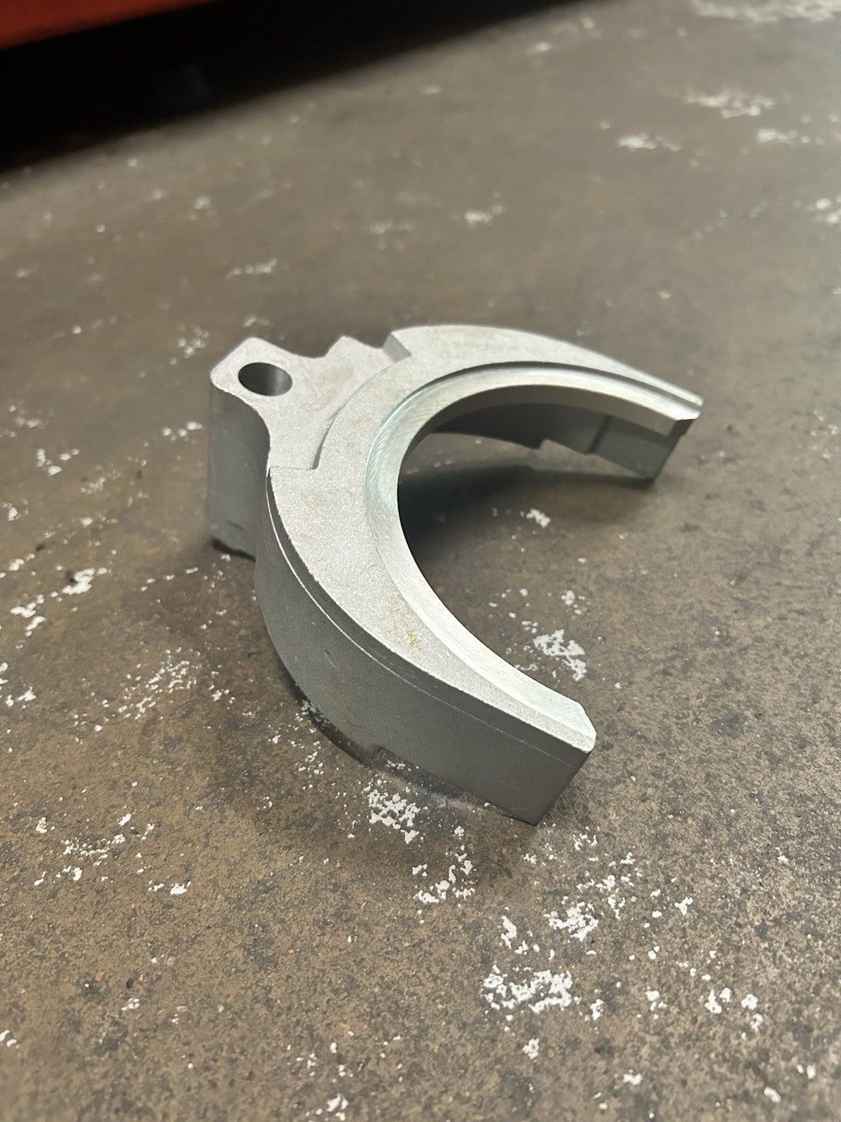 Nv4500 3-4 Fork showing the aluminum shift fork component on a rustic surface.
