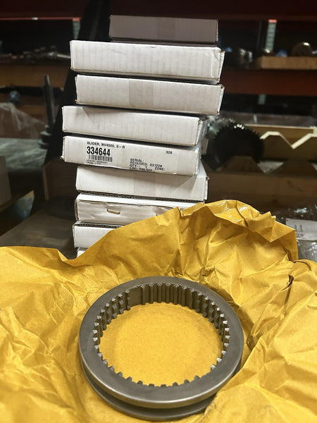 Nv4500 5th and reverse slider displayed on crumpled yellow paper with stacked boxes in the background.